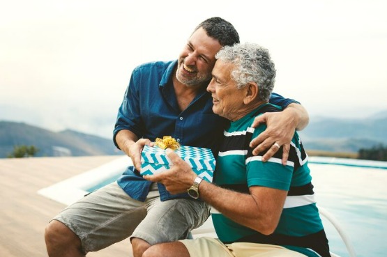 older man giving a gift to a younger man
