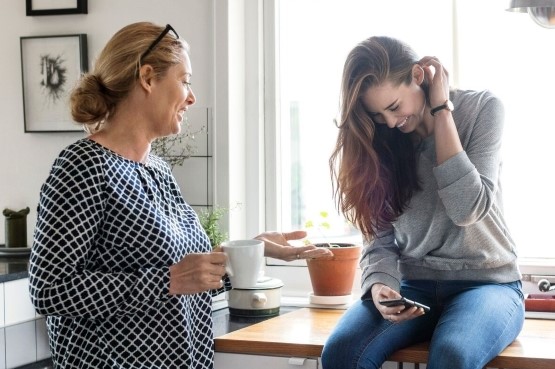 two women chatting in the kitchen