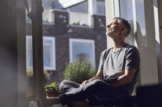 person sitting by the window on a sunny day