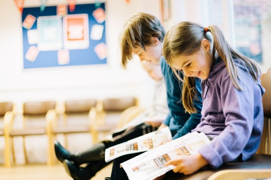children reading books in a waiting room