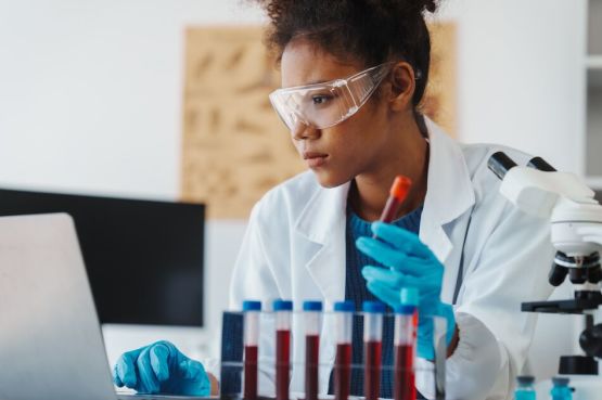 A person studying a test tube