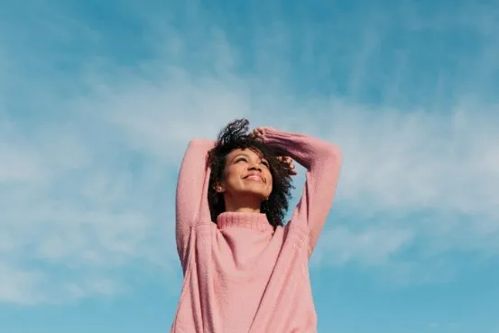person looking up at the sky and smiling