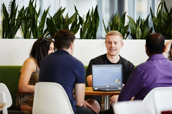 people sitting down for a meeting in the office