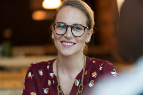 smiling person in a red shirt