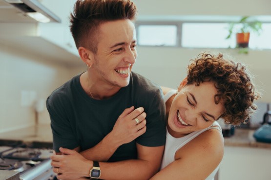 two people being playful in the kitchen 