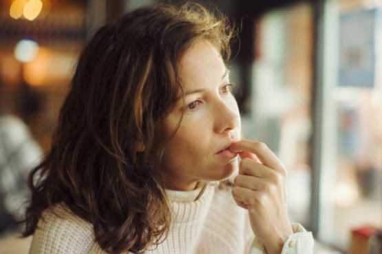 woman looking into a distance in thought