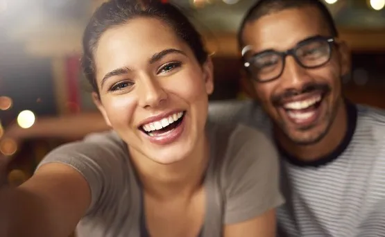 couple smiles together facing camera
