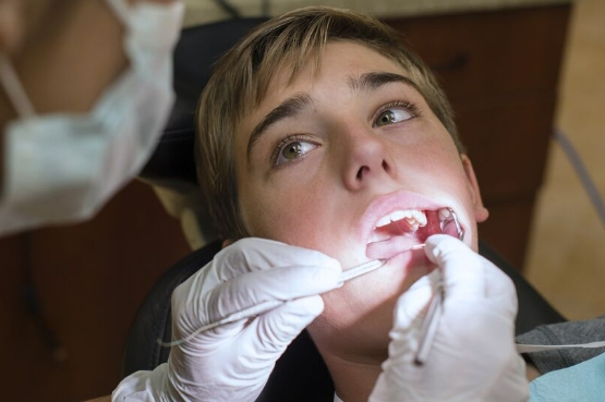 person having teeth checked at the dentist