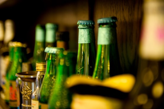 row of green bottles with tops