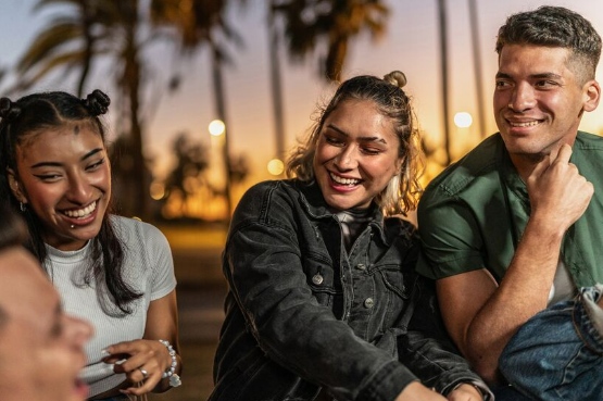 group of friends talking and laughing outdoors