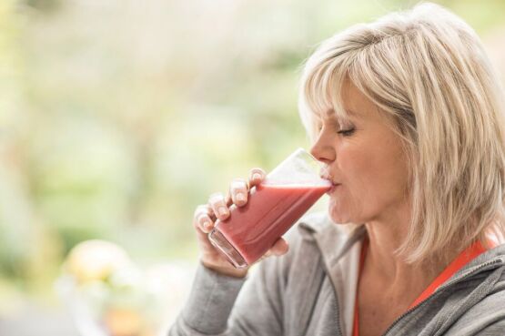 woman drinking a fruit smoothie