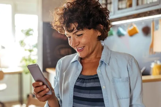 person smiling at their phone