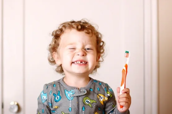 child smiling after brushing teeth