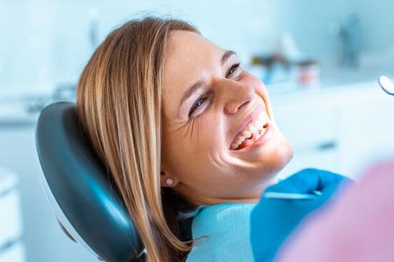 smiling patient in a dentist's chair