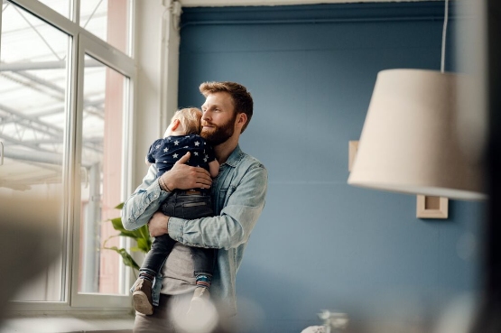 father holding baby to sleep
