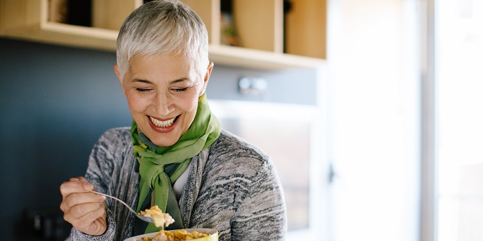 woman eating breakfast from a bowl