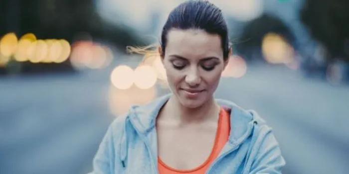 Runner woman setting her watch
