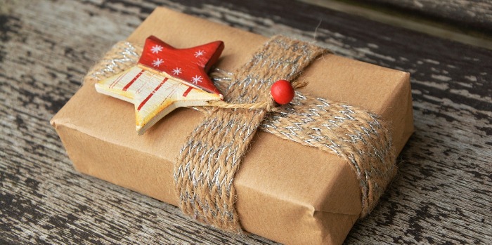 brown paper wrapped Christmas present with handmade star tag