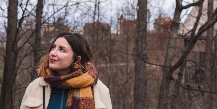 woman walking outdoors with coat and scarf