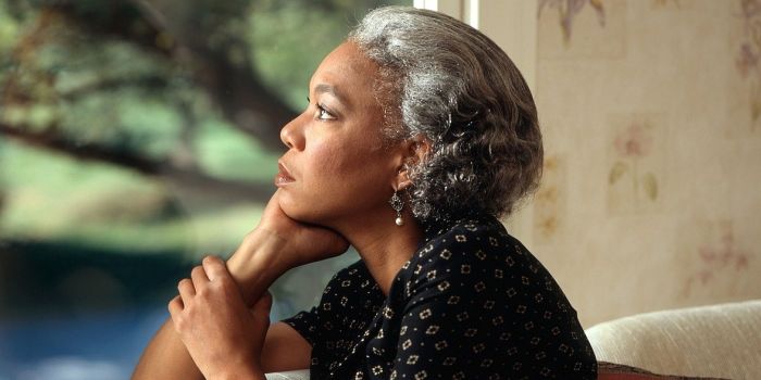 woman looking pensively out of the window