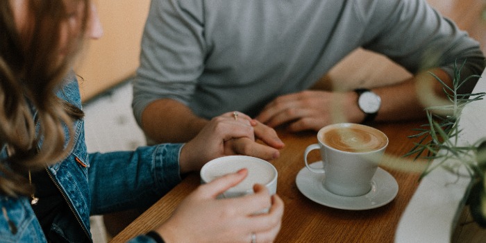 two people talking over coffee