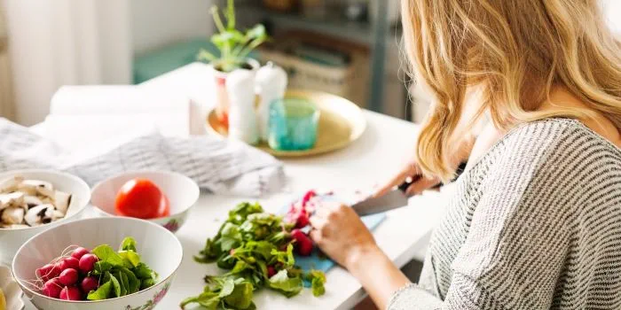 woman preparing healthy fresh food in her kitchen