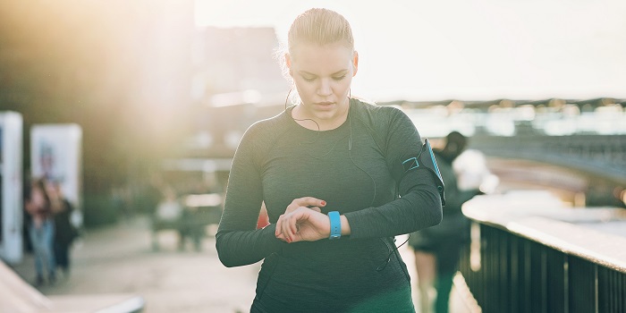 woman checking her smart watch outdoors