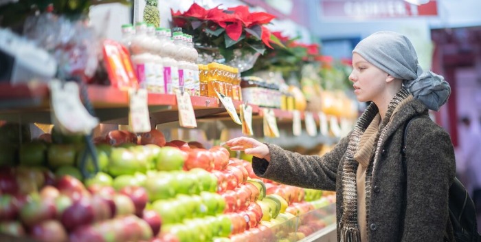 woman with a headscarf at a grocery store