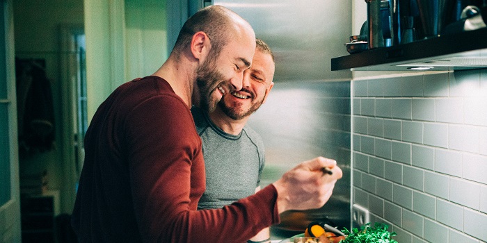 two men cooking at home