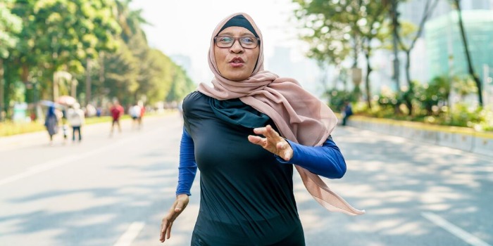 woman running in the park wearing headscarf