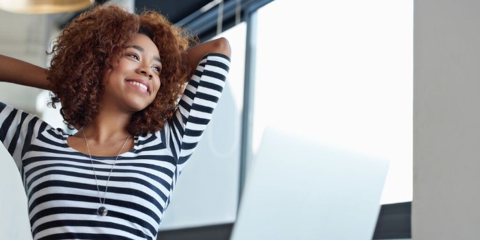 woman stretching and smiling looking out of the window