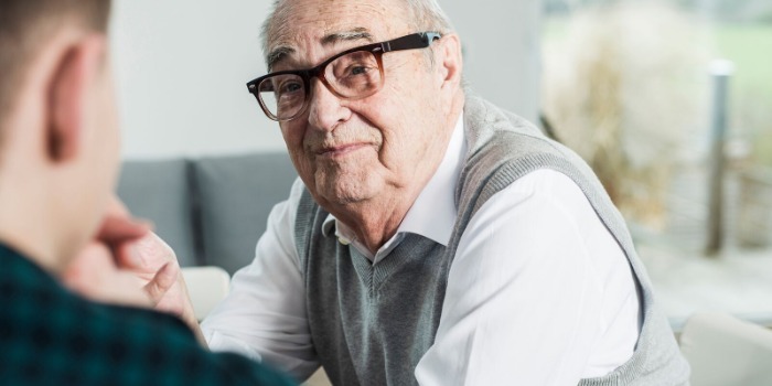 A man being visited by his carer