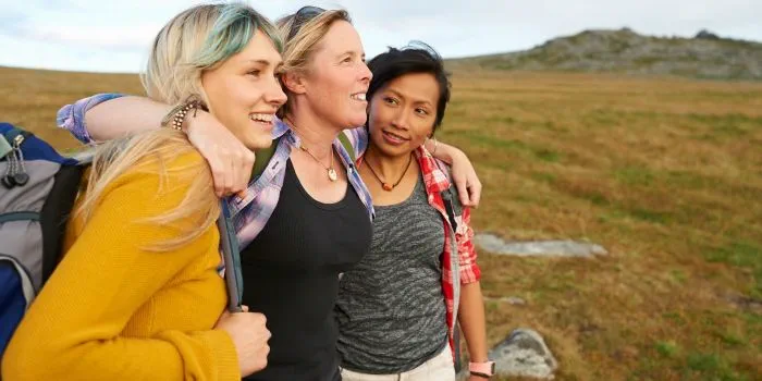 A group of people outdoors smiling
