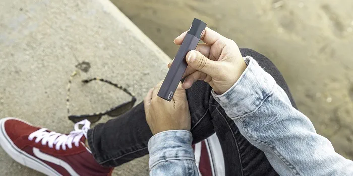 a person holding an e-cigarette
