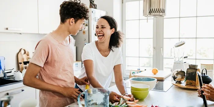 two people cooking at home