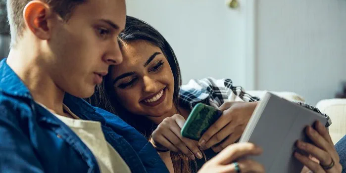 A young couple looking at a tablet