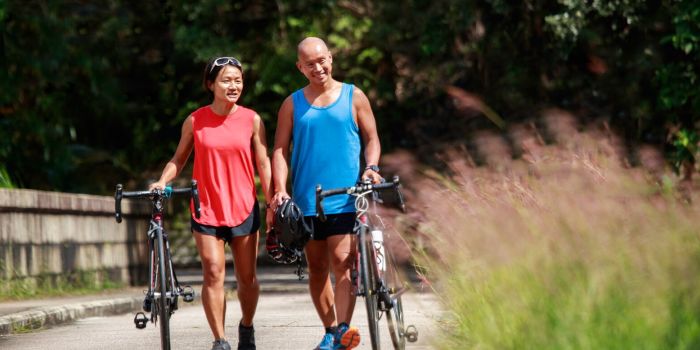 two people with cycles in the park