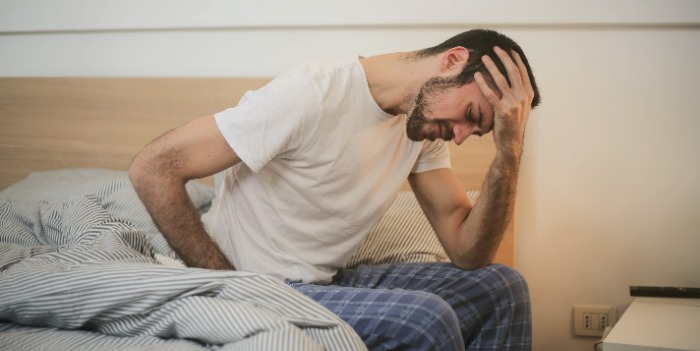 A man holding his head
