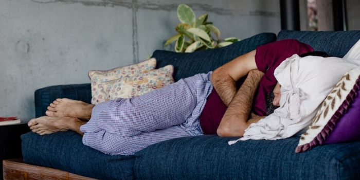 man sleeping on a sofa
