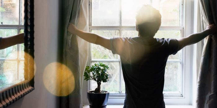 person opening the curtains