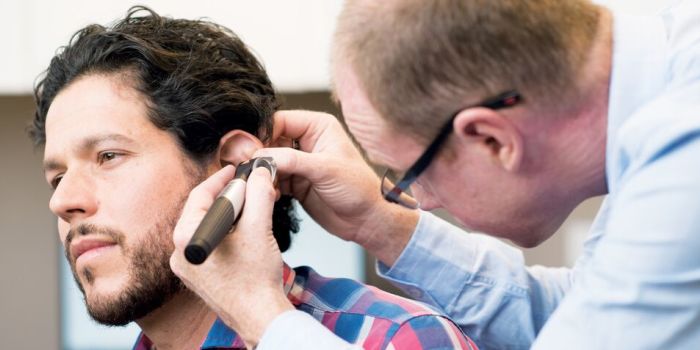 doctor examining a person's ear