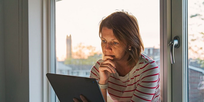 Woman watching tablet anxiously