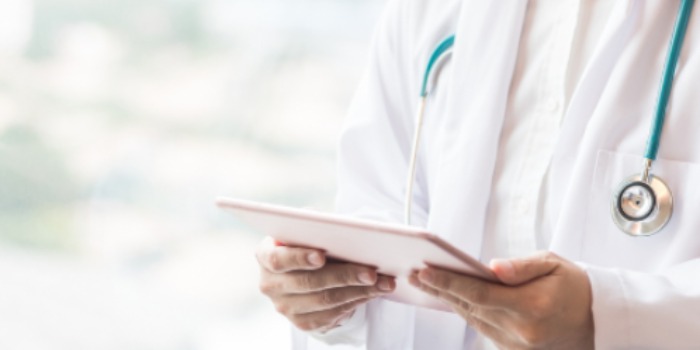doctor reading on a tablet