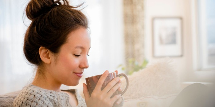 woman relaxing on the sofa with a cup of tea