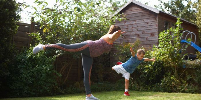 woman and child exercising in the garden