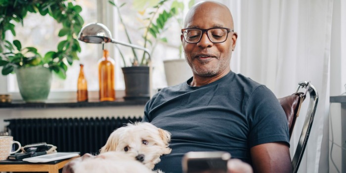 man with glasses reading on mobile