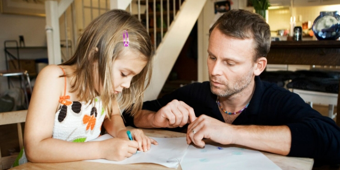 adult watching a child draw