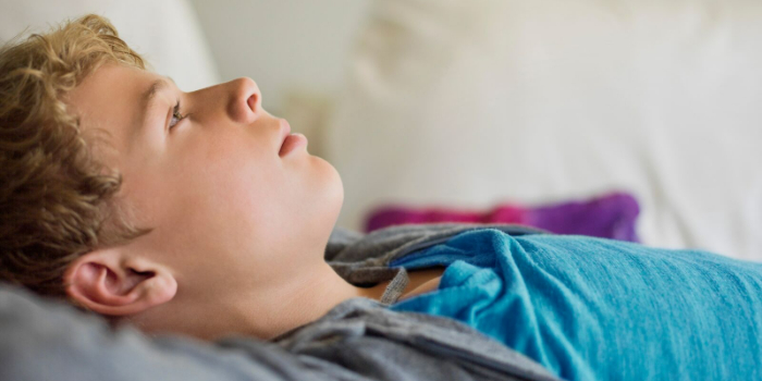 Teenager day dreaming in bed