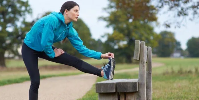 person stretching before exercise outdoors