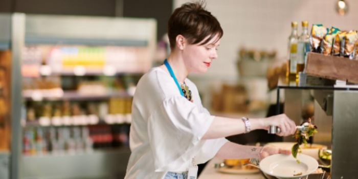 person taking salad from a buffet